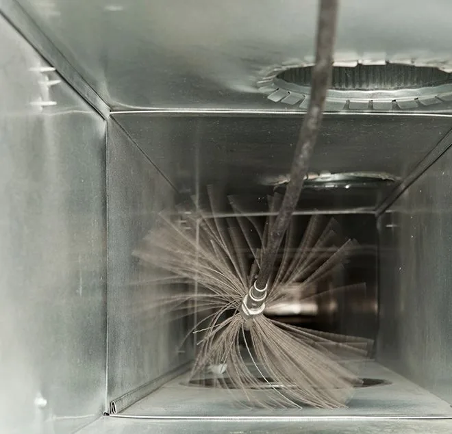 Duct cleaning brush spinning inside a metal air duct